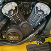 Close-up of a motorcycle engine with 'Indian' branding on a yellow background