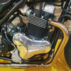 Close-up of a motorcycle engine with 'Kohon' branding on a yellow background.