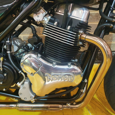 Close-up of a motorcycle engine with 'Kohon' branding on a yellow background.