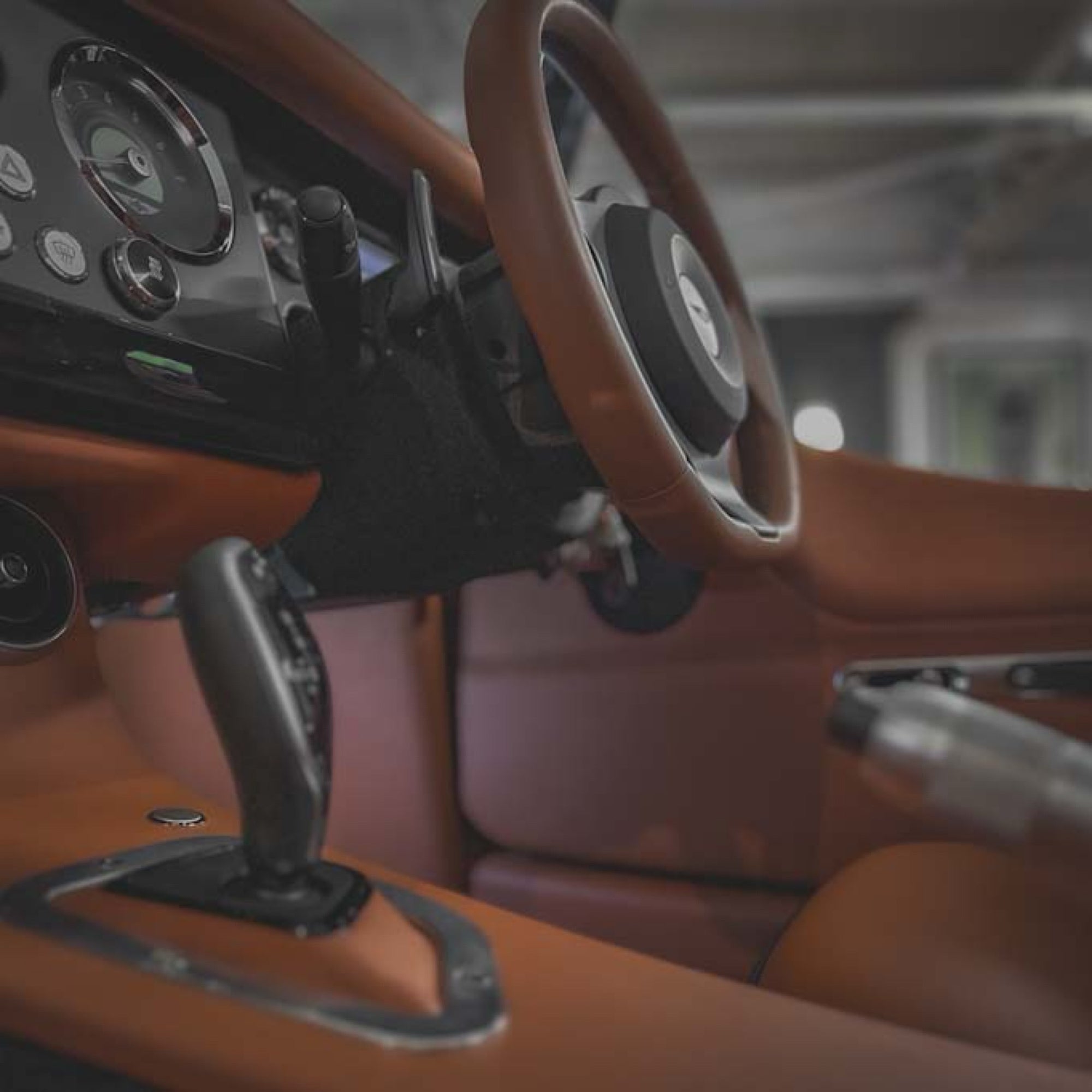 Close-up of a car's interior with steering wheel and dashboard.