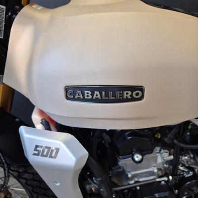 Close-up of a motorcycle with 'Cabaliero' branding on the fuel tank.