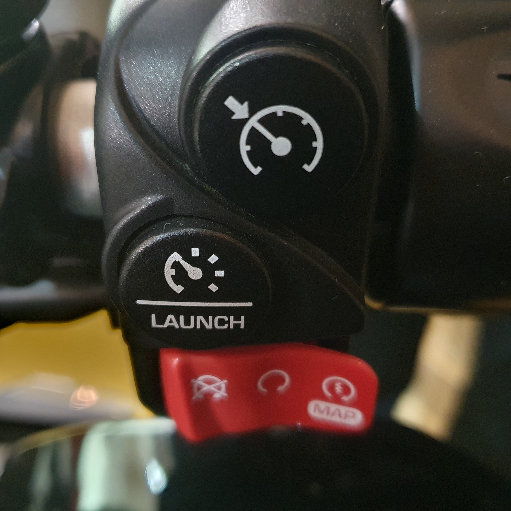 Close-up of a control panel with 'Launch' button on a vehicle, showing symbols and text.