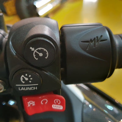 Close-up of a control panel with buttons and a brand logo on a yellow background