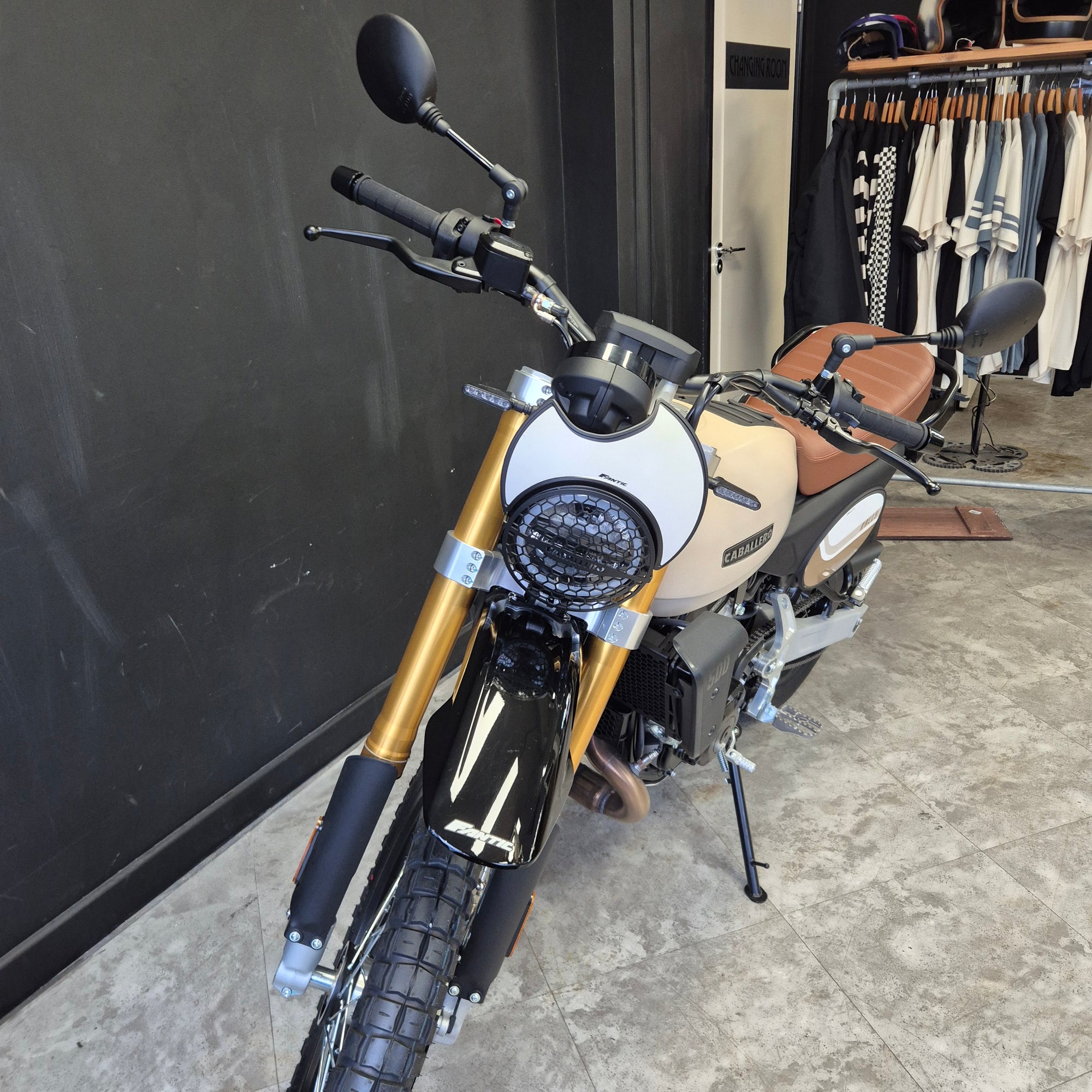 Motorcycle parked on a concrete surface with a building in the background