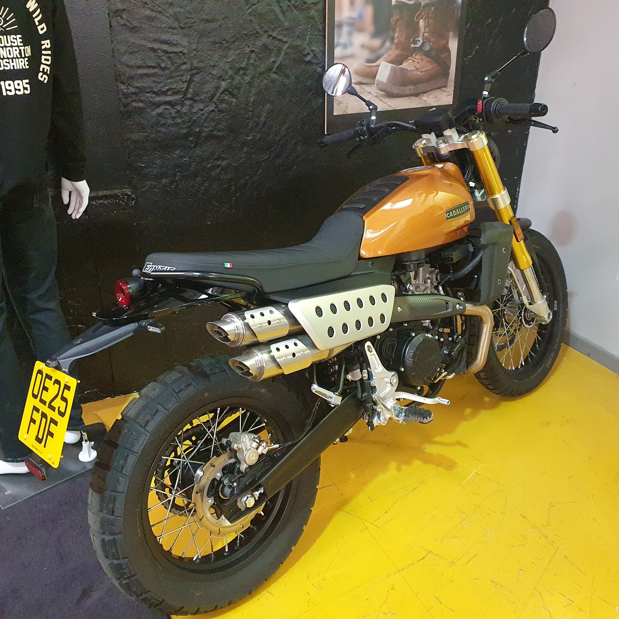 Motorcycle on display with a yellow floor and black wall background