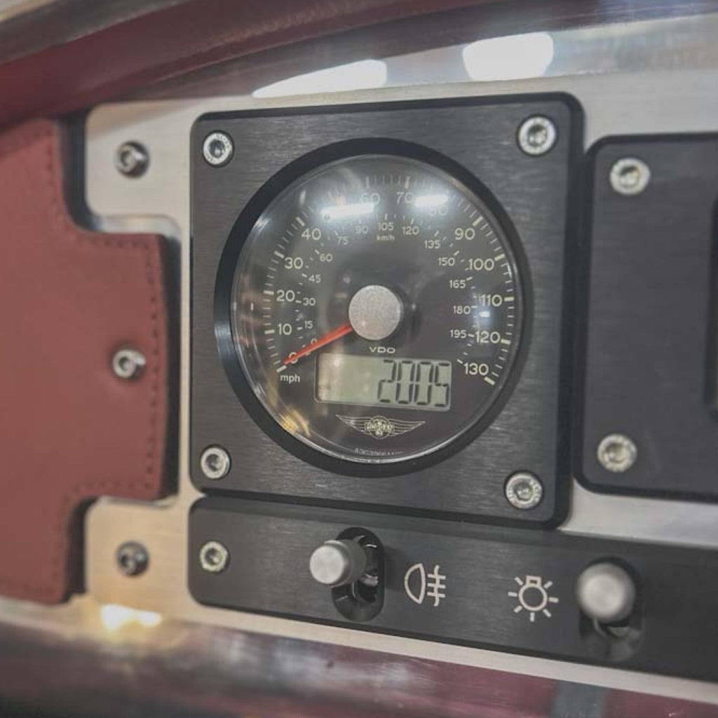 Close-up of a vehicle's speedometer and instrument panel with a digital display.