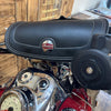 Close-up of a motorcycle handlebar with a brand logo on a wooden background