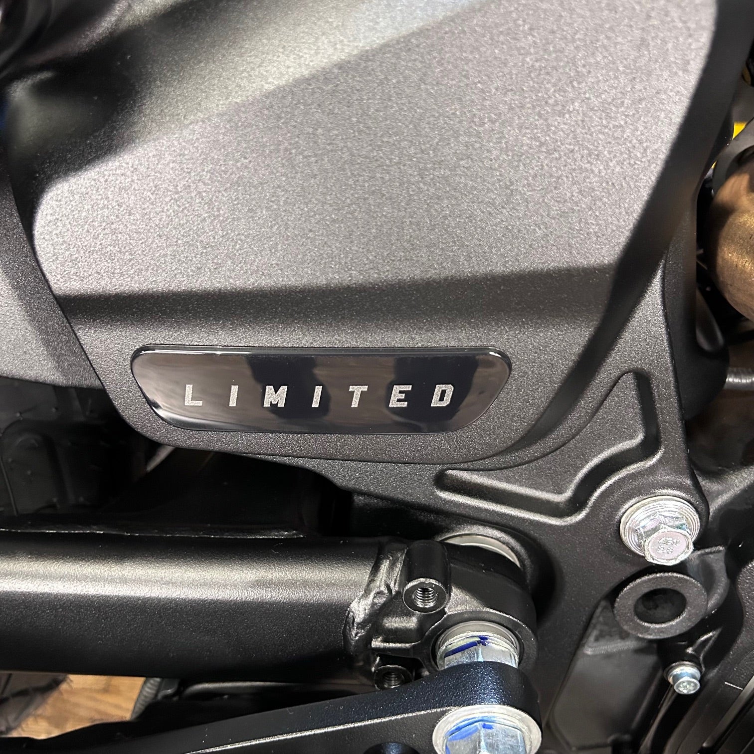 Close-up of a motorcycle with a 'LIMITED' badge on a metallic surface.