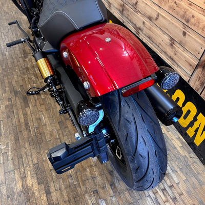 Close-up of a red motorcycle on a wooden floor