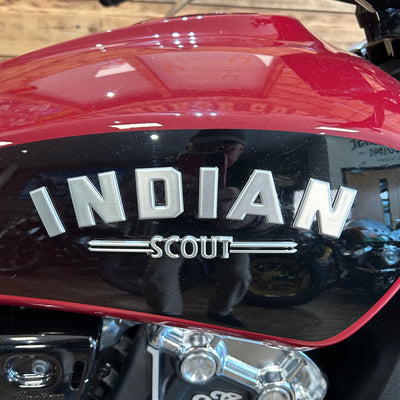 Close-up of a red motorcycle with 'Indian Scout' branding.