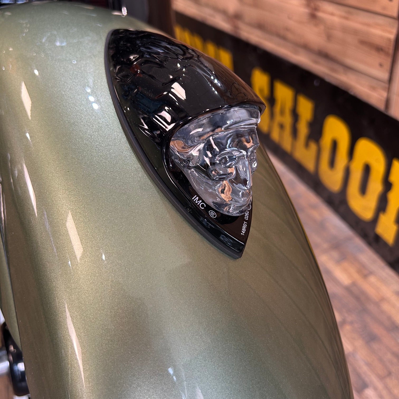 Close-up of a motorcycle headlight with a blurred background