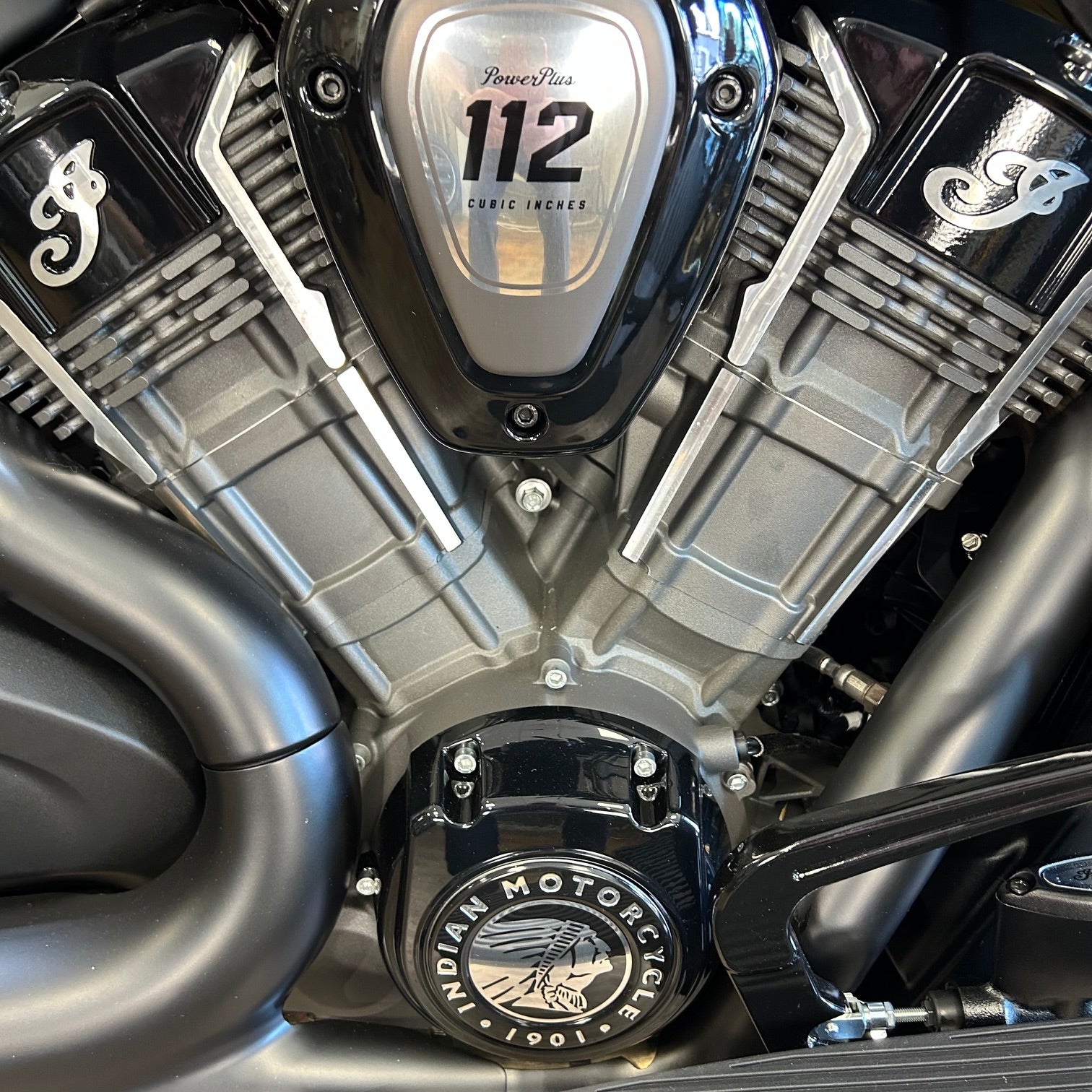 Close-up of a motorcycle engine with 'Indian Motorcycle' branding.
