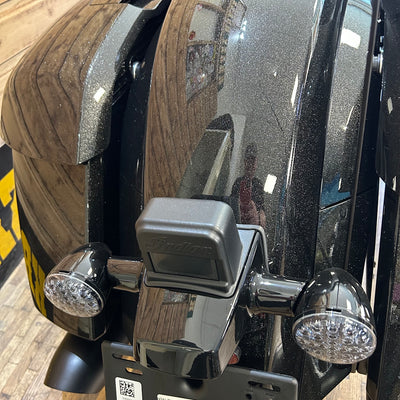 Close-up of a vehicle's hitch receiver with a trailer attached.
