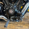 Close-up of a motorcycle engine with 'Indian Motorcycle' logo on a wooden floor.