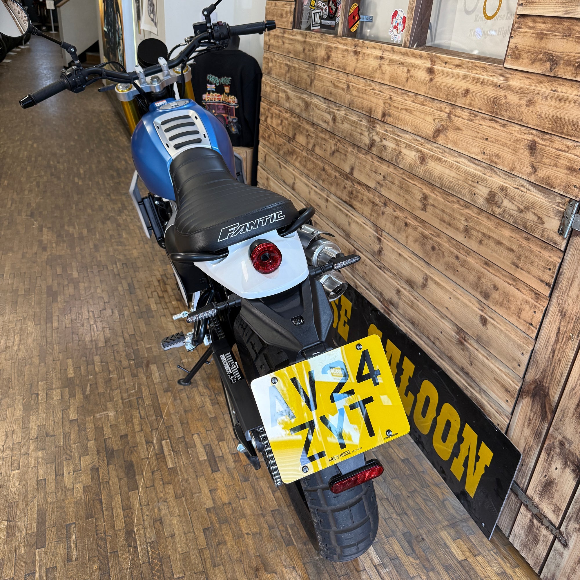Motorcycle with a yellow license plate in a showroom setting