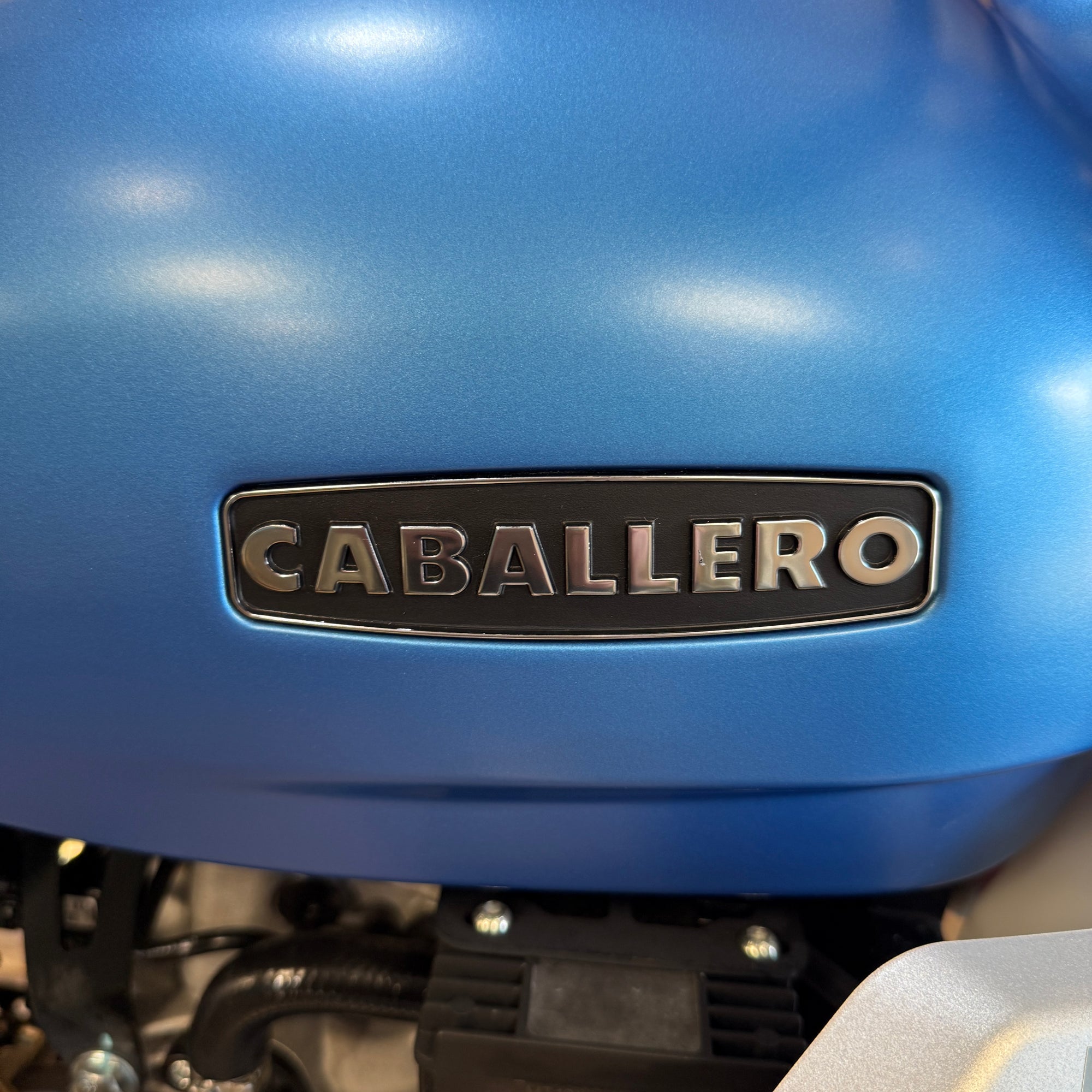 Close-up of a blue vehicle with 'Caballero' logo