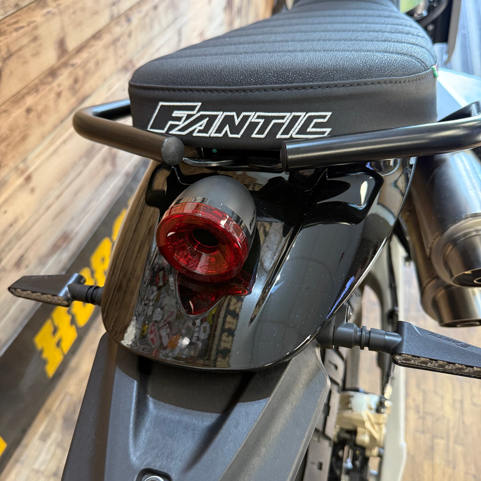 Close-up of a motorcycle with 'Fantic' branding on the seat.