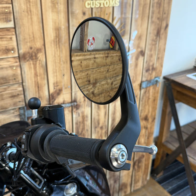 Motorcycle mirror on handlebar with wooden background