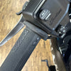 Close-up of a motorcycle handlebar with 'Indian' branding on a wooden floor background