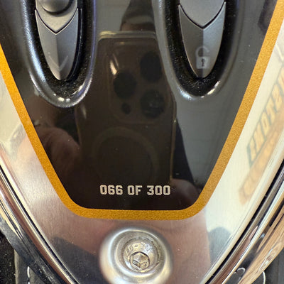 Close-up of a golf club head with '066 OF 300' text on a reflective surface.