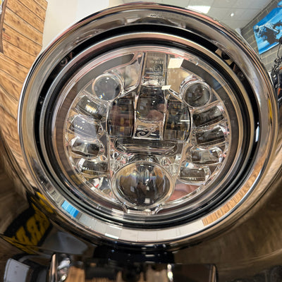 Close-up of a motorcycle headlight with chrome finish