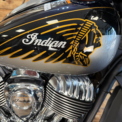 Close-up of a motorcycle with 'Indian' logo on the fuel tank.