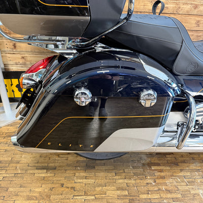 Close-up of a motorcycle with 'ELITE' branding on a wooden floor.