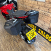 Motorcycle with a yellow license plate on a wooden floor