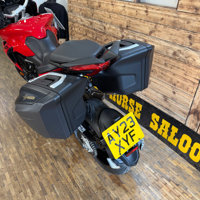 Motorcycle with a yellow license plate on a wooden floor