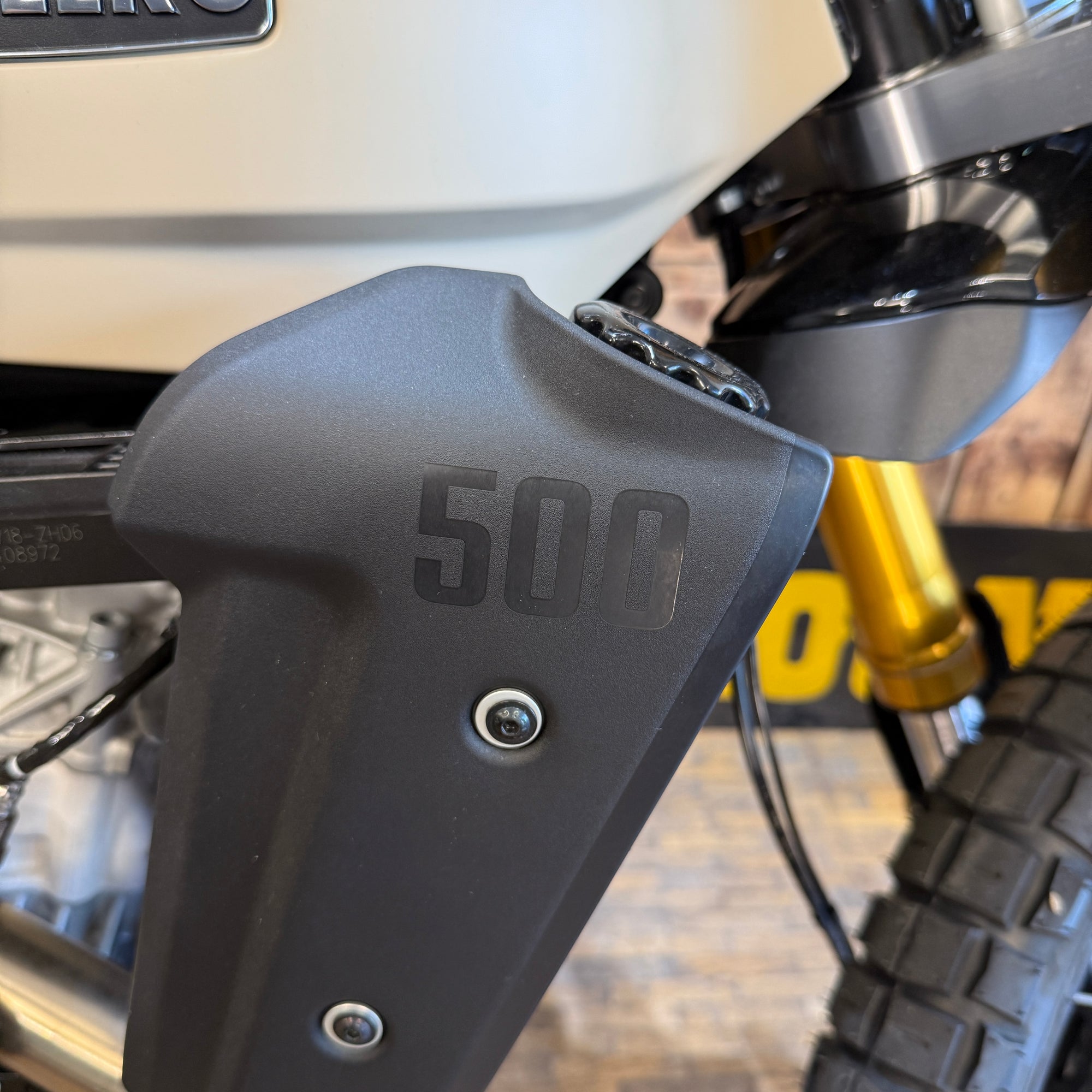 Close-up of a motorcycle handlebar with '500' branding on a blurred background