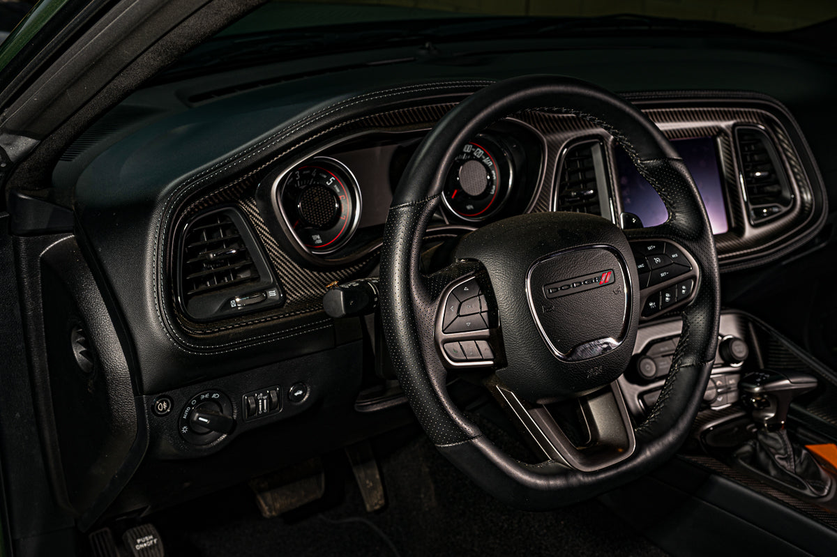Car interior with steering wheel and dashboard in a dark setting