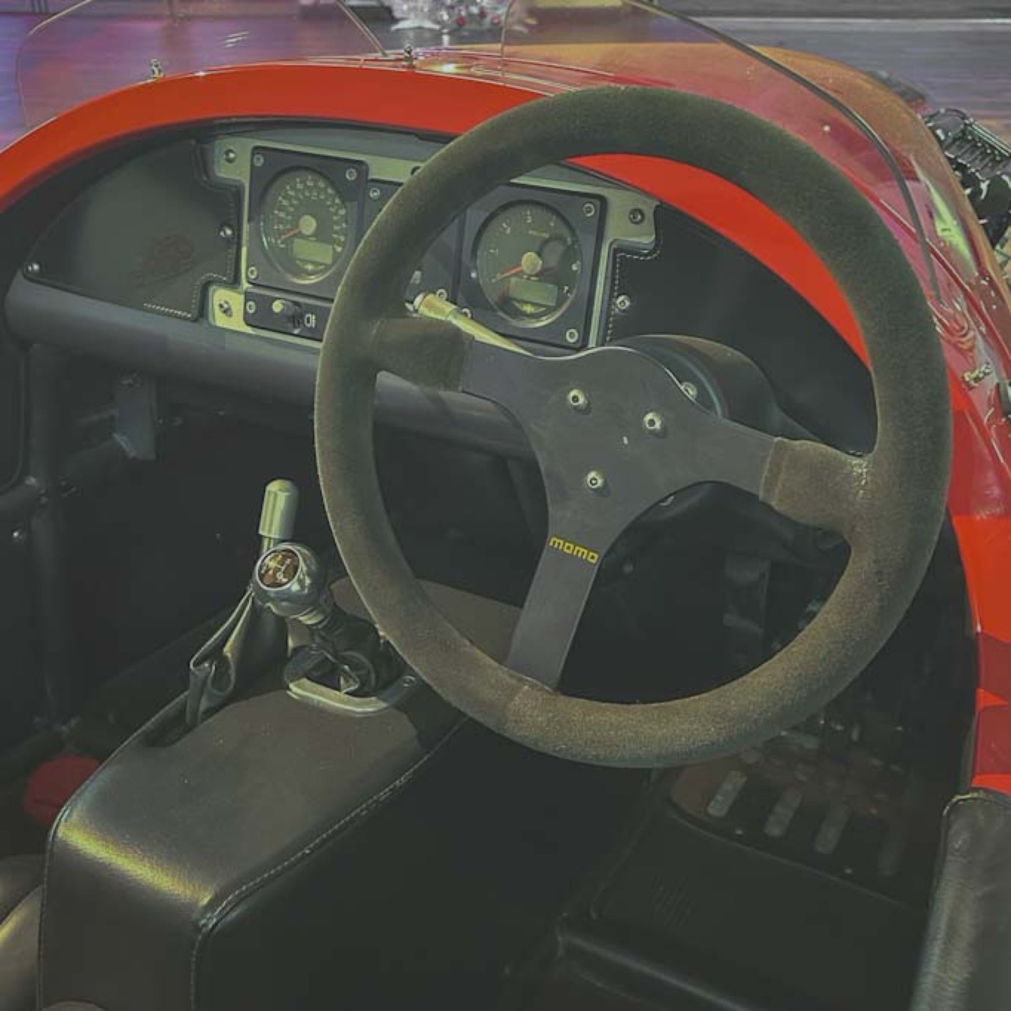 Steering wheel with MOMO logo in a car interior