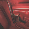 Close-up of a red leather seat with metallic door handle
