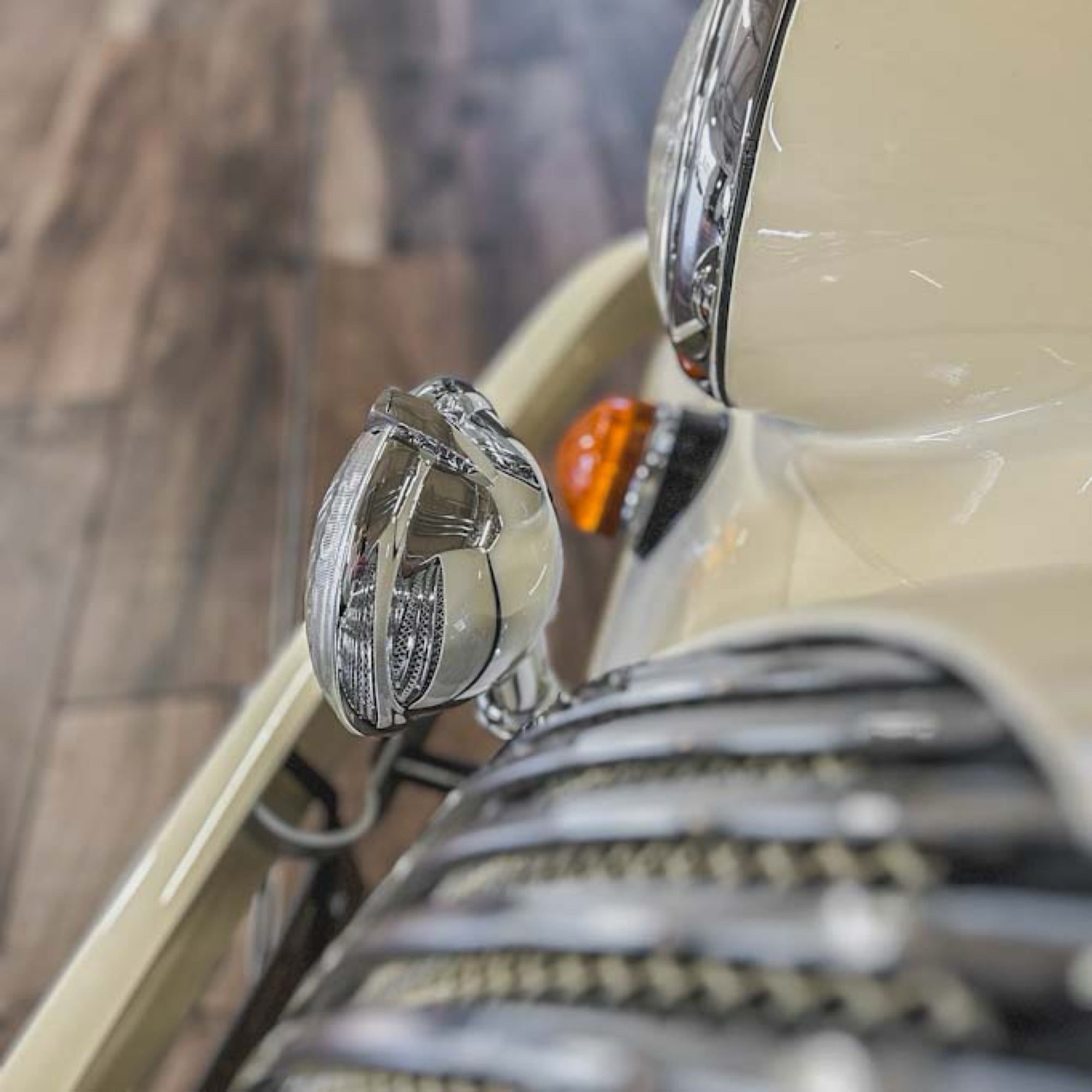 Close-up of a vintage car's headlight and grille