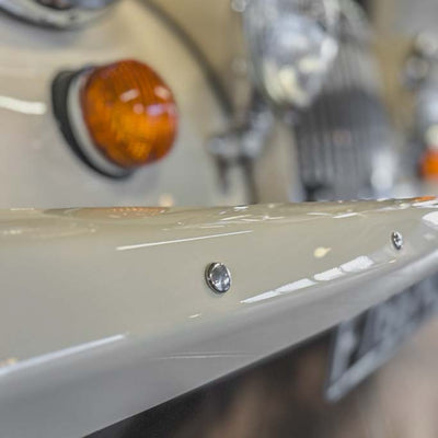 Close-up of a motorcycle's turn signal and front fender.