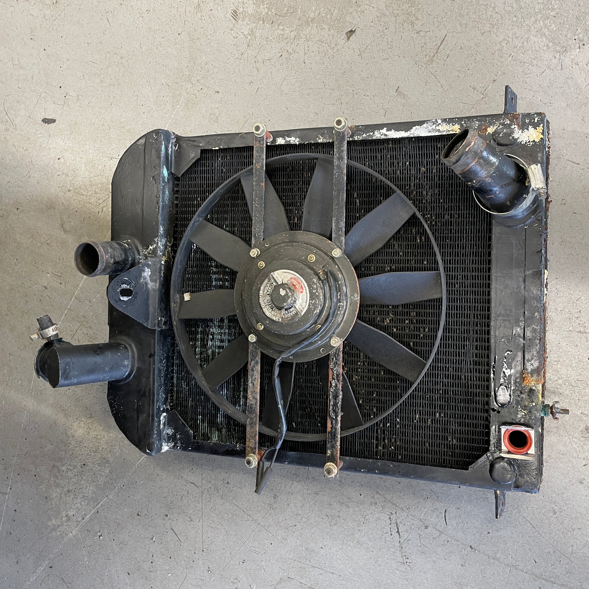 Car radiator with fan on a gray surface