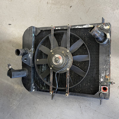 Car radiator with fan on a gray surface