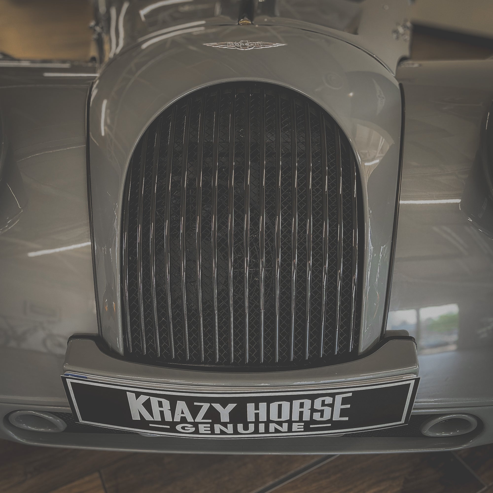 Close-up of a car grille with 'Krazy Horse Genuine' branding.