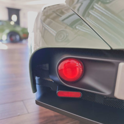 Close-up of a car's red taillight with a blurred background