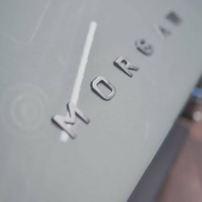 Close-up of a clock with 'Morgan' branding on a gray background