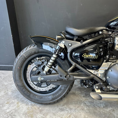 Close-up of a motorcycle with 'Super Meteor' branding on a gray floor.