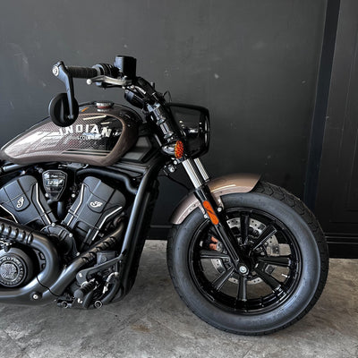 Black motorcycle with visible branding against a dark background
