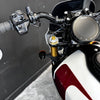 Close-up of a motorcycle handlebar with control buttons and Indian logo.