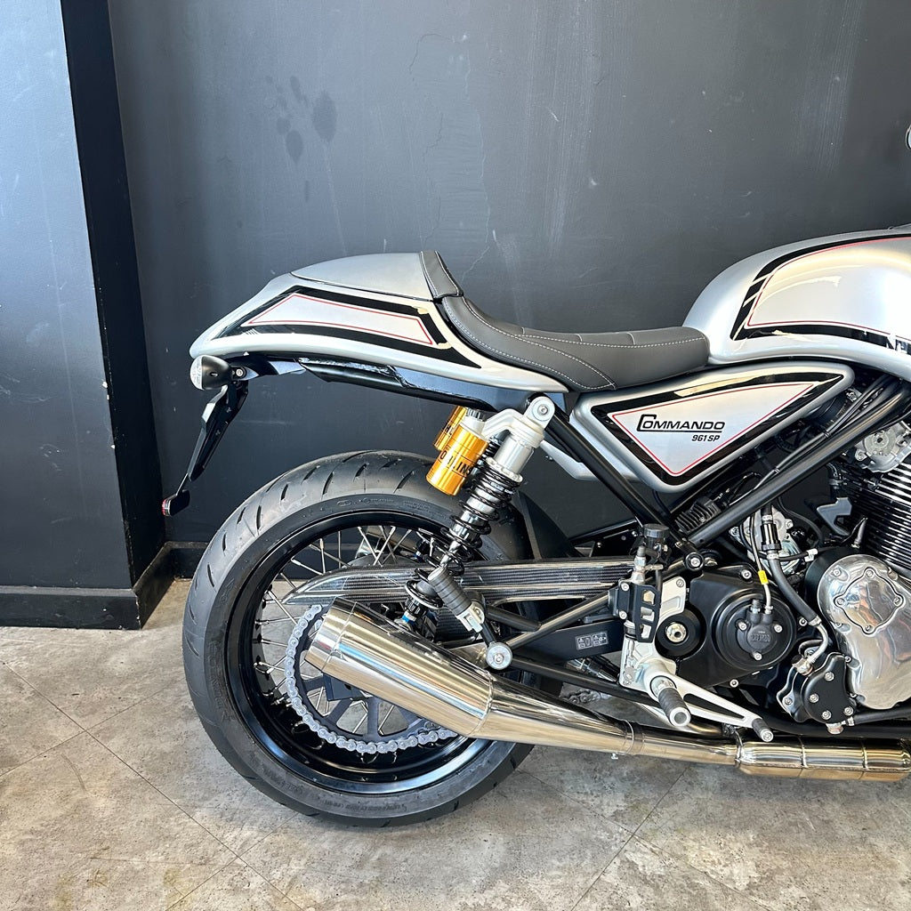 Motorcycle parked against a black wall