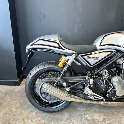 Motorcycle parked against a black wall