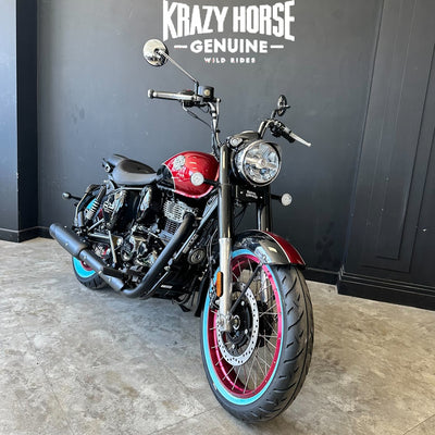 Motorcycle with red and black design parked indoors against a dark wall with 'Krazy Horse' branding.