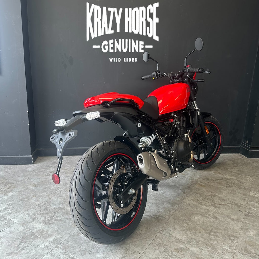 A red and black Kawasaki Zongli motorcycle photographed indoors against a dark gray wall with the text 'KRAZY HORSE GENUINE WILD RIDES' above it.