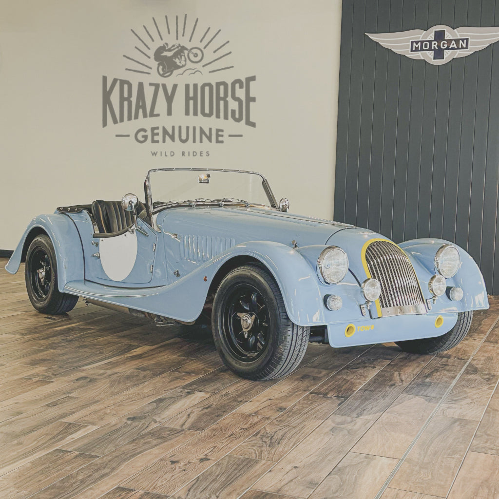 Vintage-style blue car on a wooden floor with 'Krazy Horse' and 'Morgan' branding.