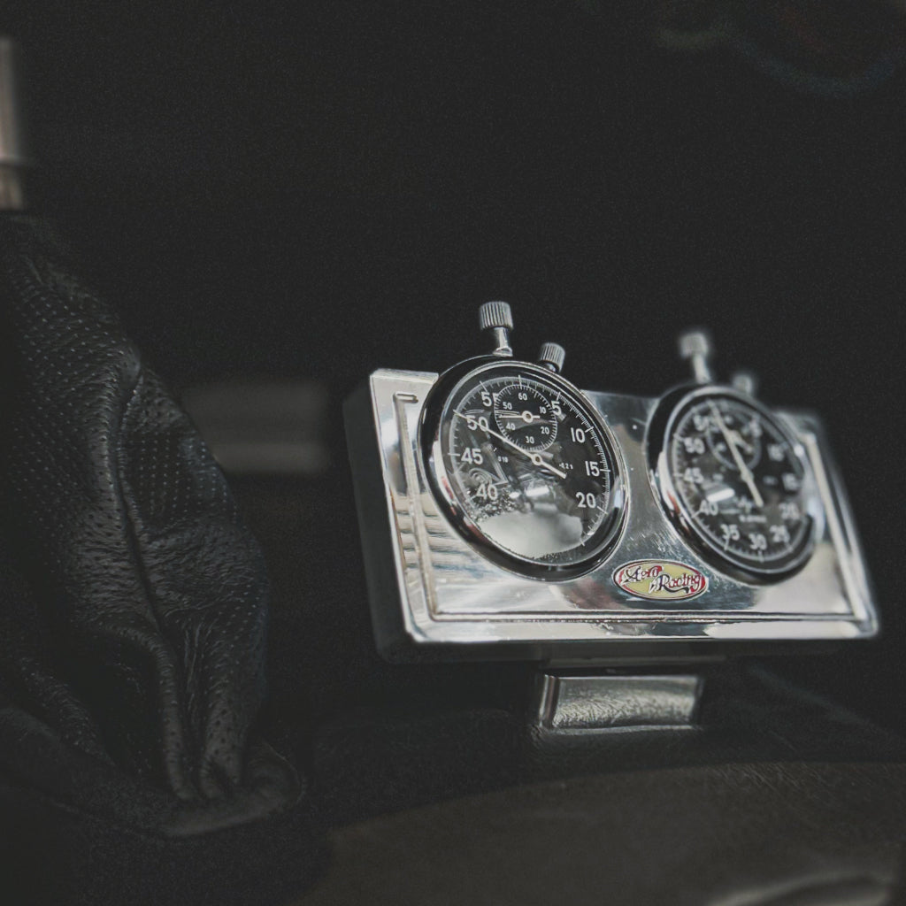 Close-up of a vintage speedometer and tachometer in a car dashboard.